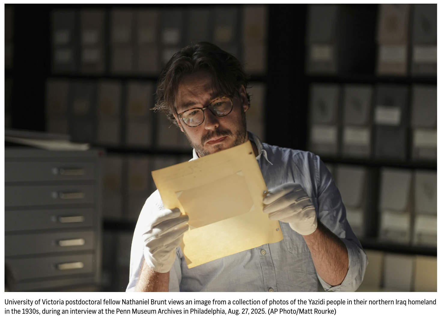 Nathaniel Brunt looking at a document in an archive